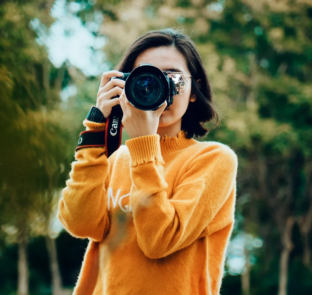 a woman holding a camera