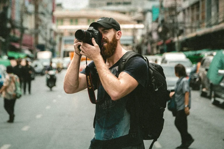 a man with a backpack taking a picture of himself